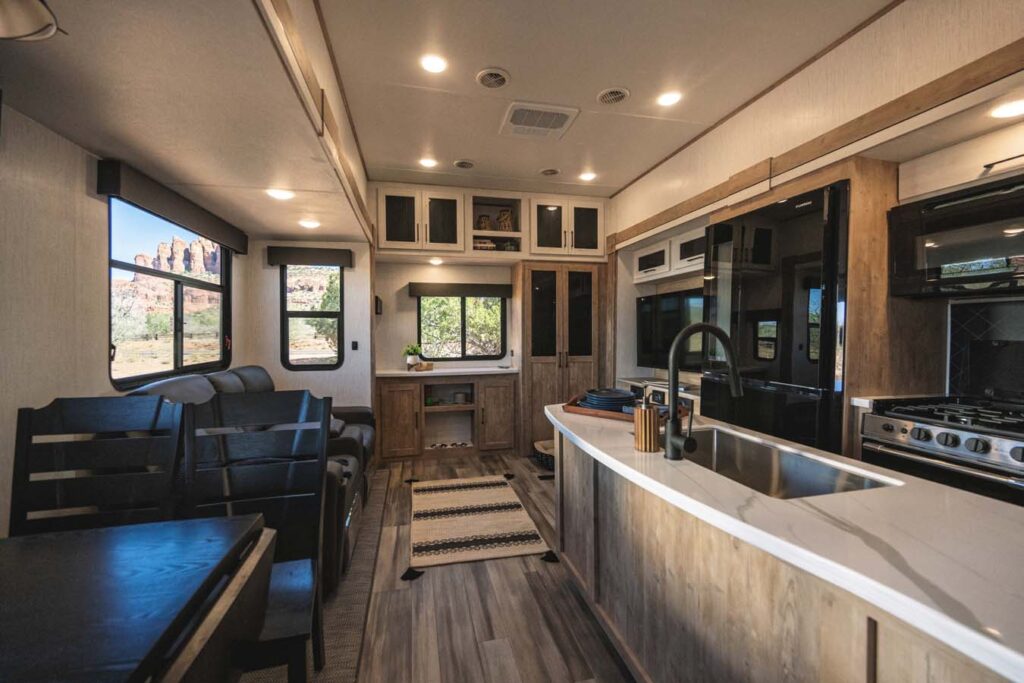 Interior of the 2025 Heartland RV Bighorn 391MFB Fifth Wheel featuring a spacious living room and kitchen area.