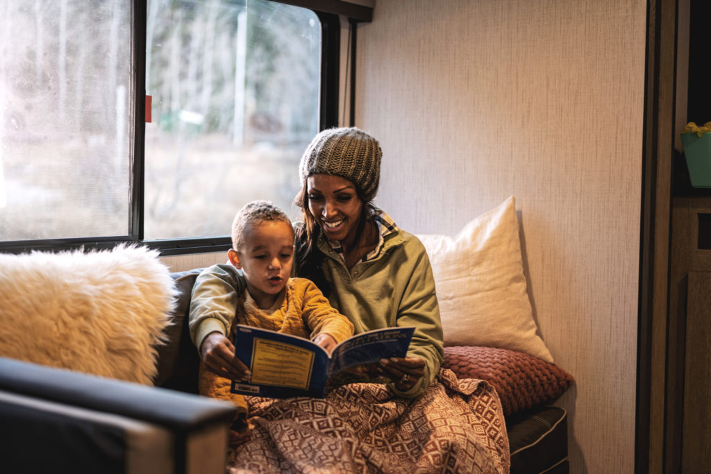 Decorating RV interiors can be easy by adding throw pillows and blankets
