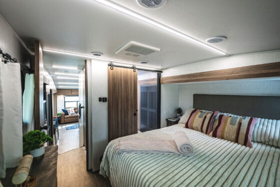 Close-up view of the interior kitchen area in the Heartland Corterra fifth-wheel RV, featuring modern appliances, a large countertop, and stylish cabinetry.