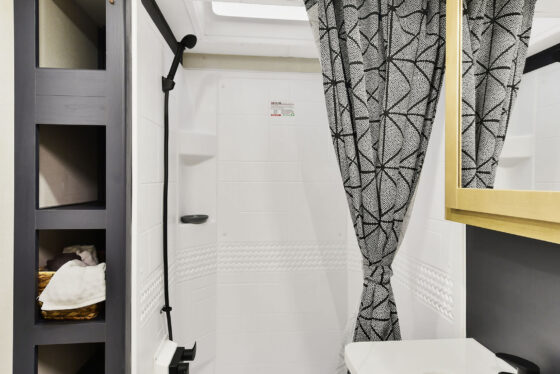 Modern bathroom inside a Heartland Torque RV with sleek fixtures, a shower, and a stylish vanity