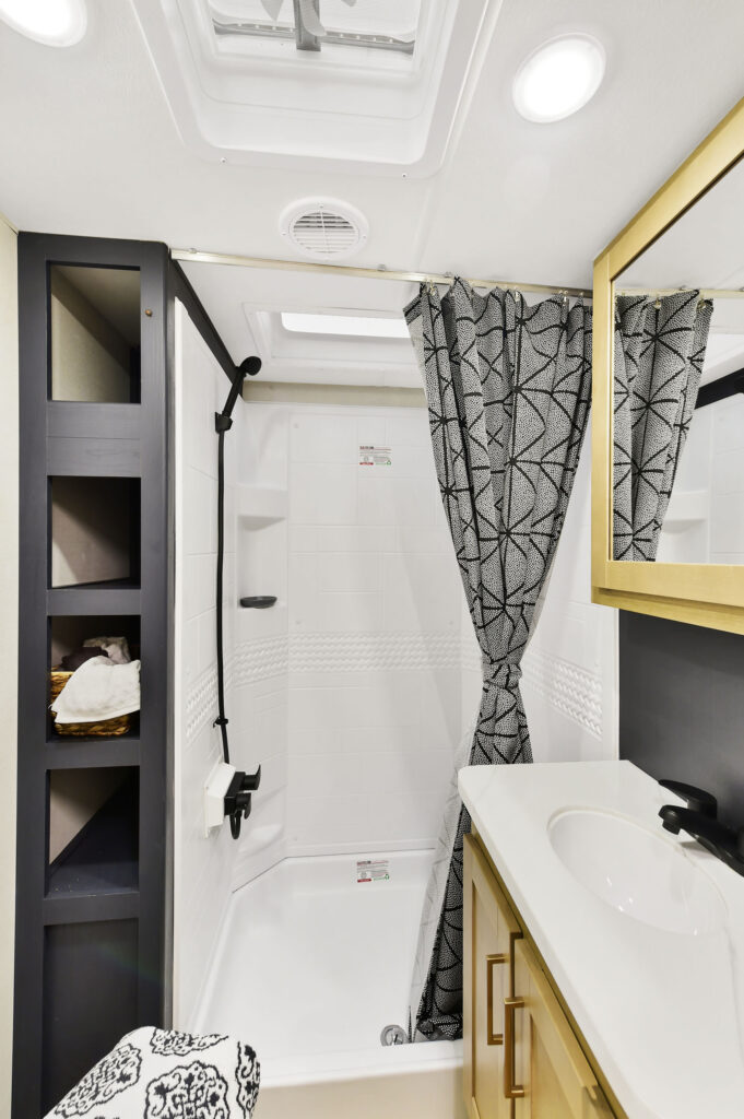 Modern bathroom inside a Heartland Torque RV with sleek fixtures, a shower, and a stylish vanity