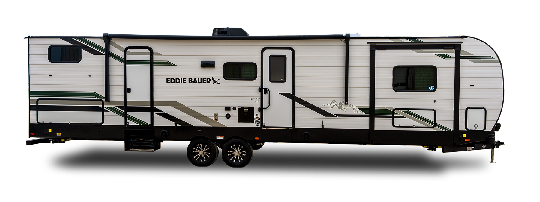 A white Eddie Bauer travel trailer with green and black stripes, two axles, multiple windows, and a door near the front. The trailer has outdoor utility connections and mountain graphics on its side.