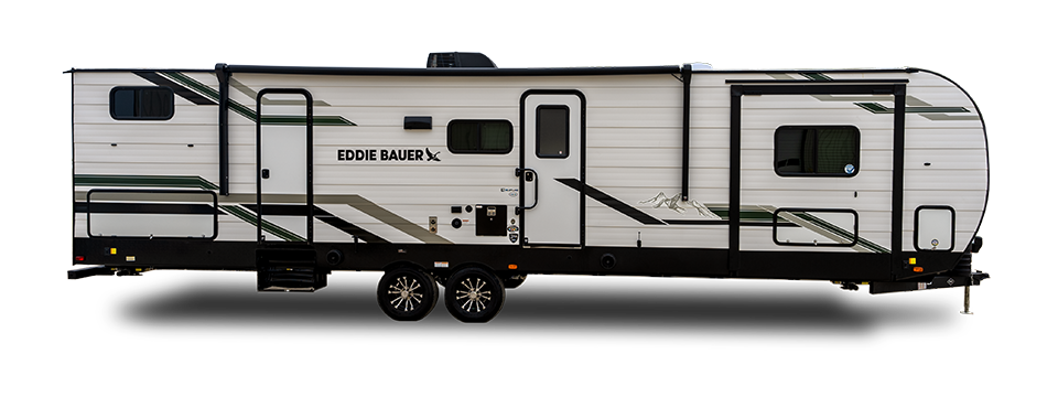 Side view of a white Eddie Bauer travel trailer with green and black accents, two doors, several windows, two axles, and outdoor storage compartments.