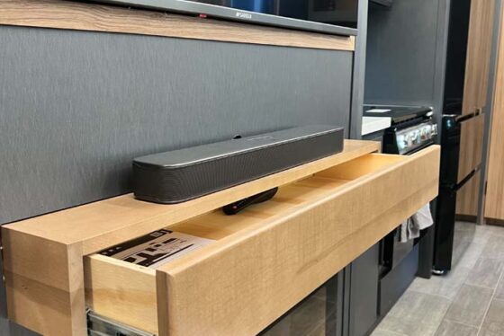 Close-up of the pull-out storage or feature above the fireplace in the living room of a Heartland Corterra fifth-wheel RV.