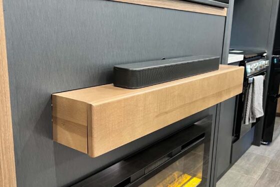 Close-up of the fireplace in the living room of a Heartland Corterra fifth-wheel RV, adding warmth and ambiance to the space.
