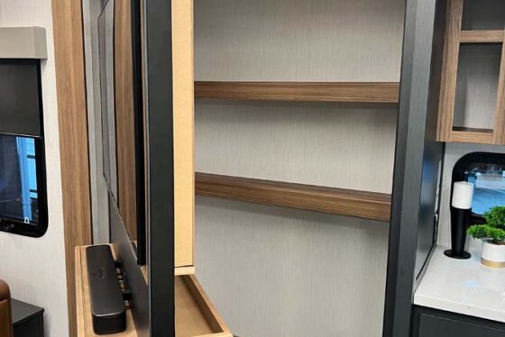 Interior view of a spacious storage area in the Heartland Corterra fifth-wheel RV, showcasing large cabinets and ample space for storage.