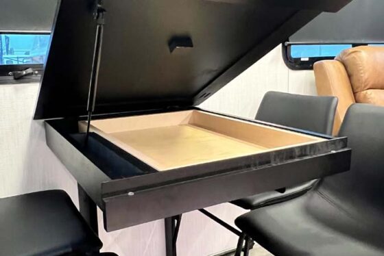 Close-up view of the lift-up table inside the Heartland Corterra fifth-wheel RV, showcasing its modern design and functional feature.