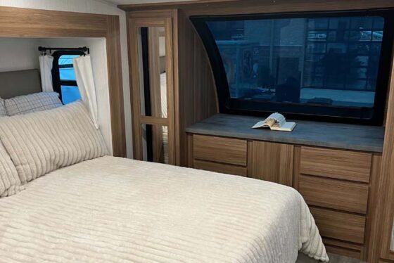 Interior view of the Heartland Corterra fifth-wheel RV featuring a modern kitchen with high-end appliances, countertops, and cabinetry.