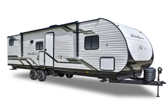 A white travel trailer with black and green accents, two axles, several windows, a side door, and an awning, shown isolated on a black background.