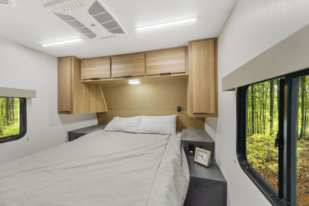 Interior view of the 2024 Heartland Cyclone CT 30.3RL Fifth Wheel Toy Hauler bedroom, featuring a queen-sized bed, stylish cabinetry, and modern décor.