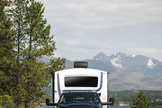 Exterior of the 2024 Heartland Cyclone 4008 Fifth Wheel Toy Hauler, showcasing its sleek design, multiple slide-outs, and large tinted windows.