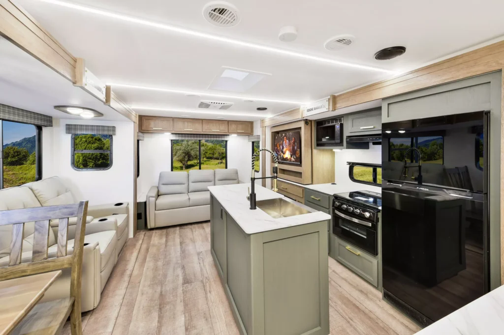 Interior view of the 2025 Eddie Bauer CWEL 3311RL RV with kitchen, dining area, and living space.