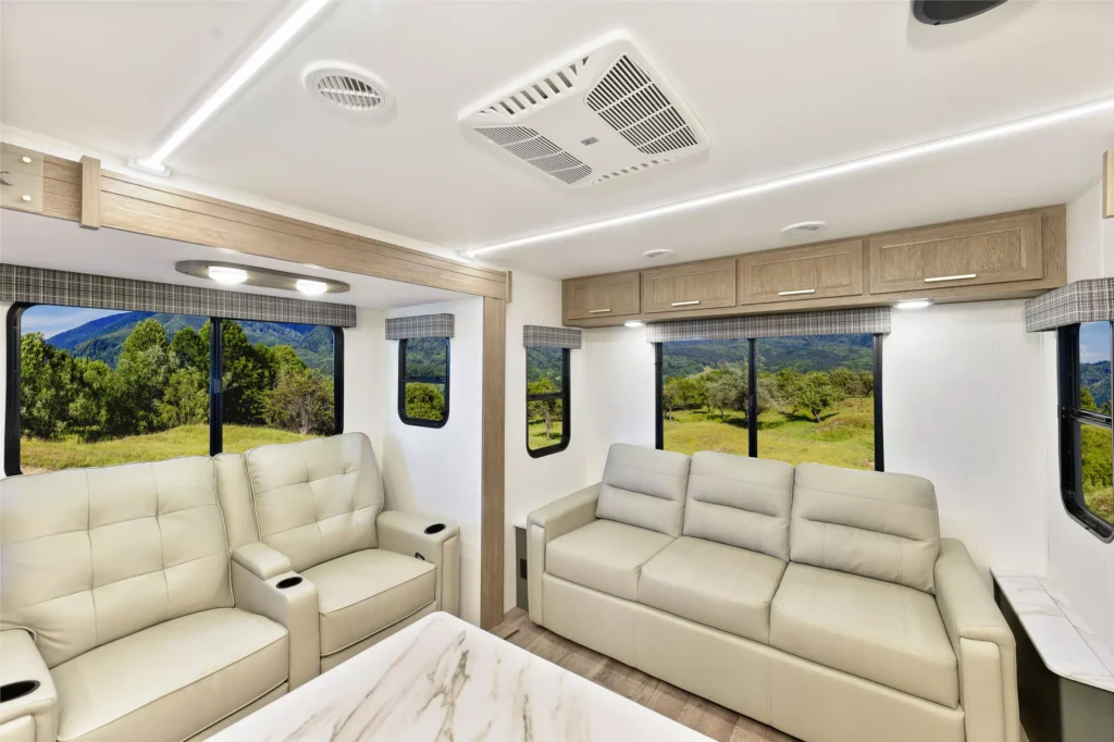 Living room in the 2025 Eddie Bauer CWEL 3311RL RV with two couches and a TV.