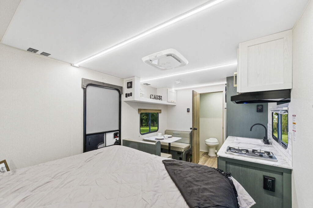 Compact and modern interior of the 2025 Heartland RV EBL 17RBL, featuring a functional kitchen, cozy dining area, and stylish finishes.